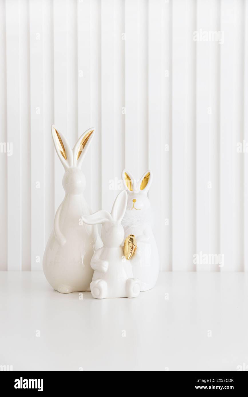 Easter rabbits figurines and eggs on white background. Easter ...