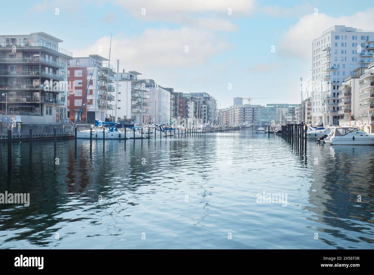 Cityscape at a Dockan Marina in Malmö, where boats dock in calm waters . Concepts: urban expansion, waterfront living, Malmö Stock Photo