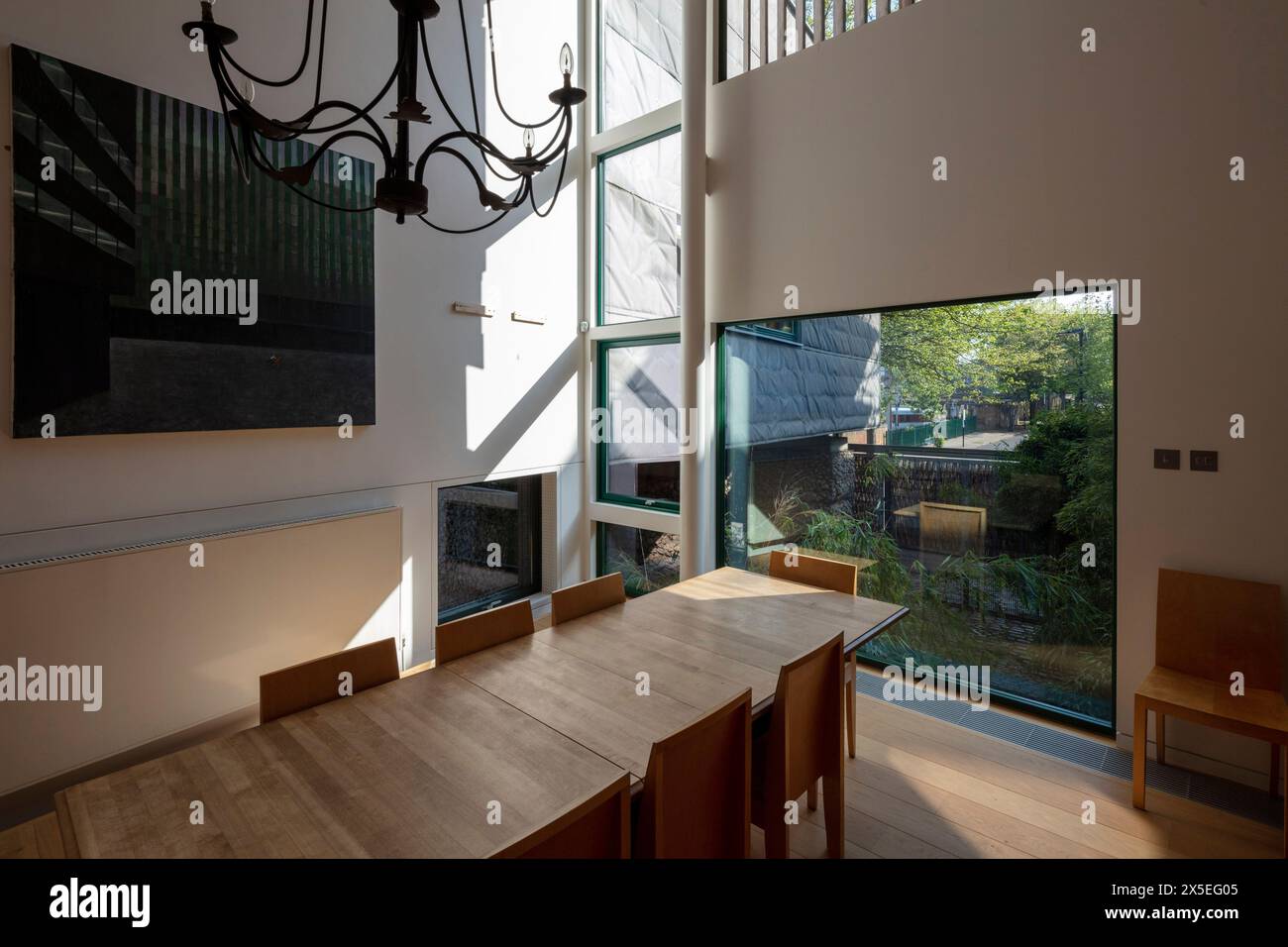 Dining room with large picture window. Straw Bale House, Islington