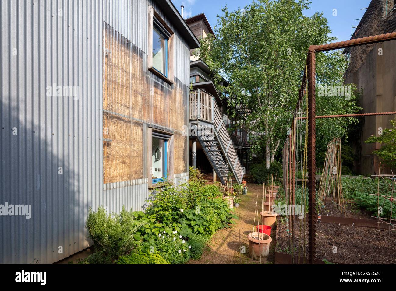 Corrugated plastic wraps around the straw bales to create part of the