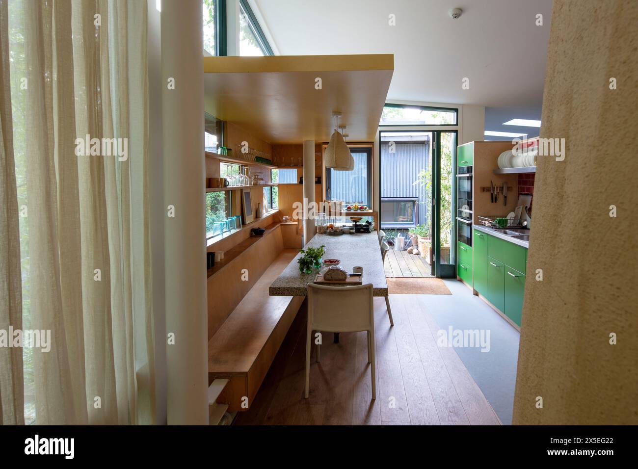 View of the kitchen looking out towards the balcony. Straw Bale House