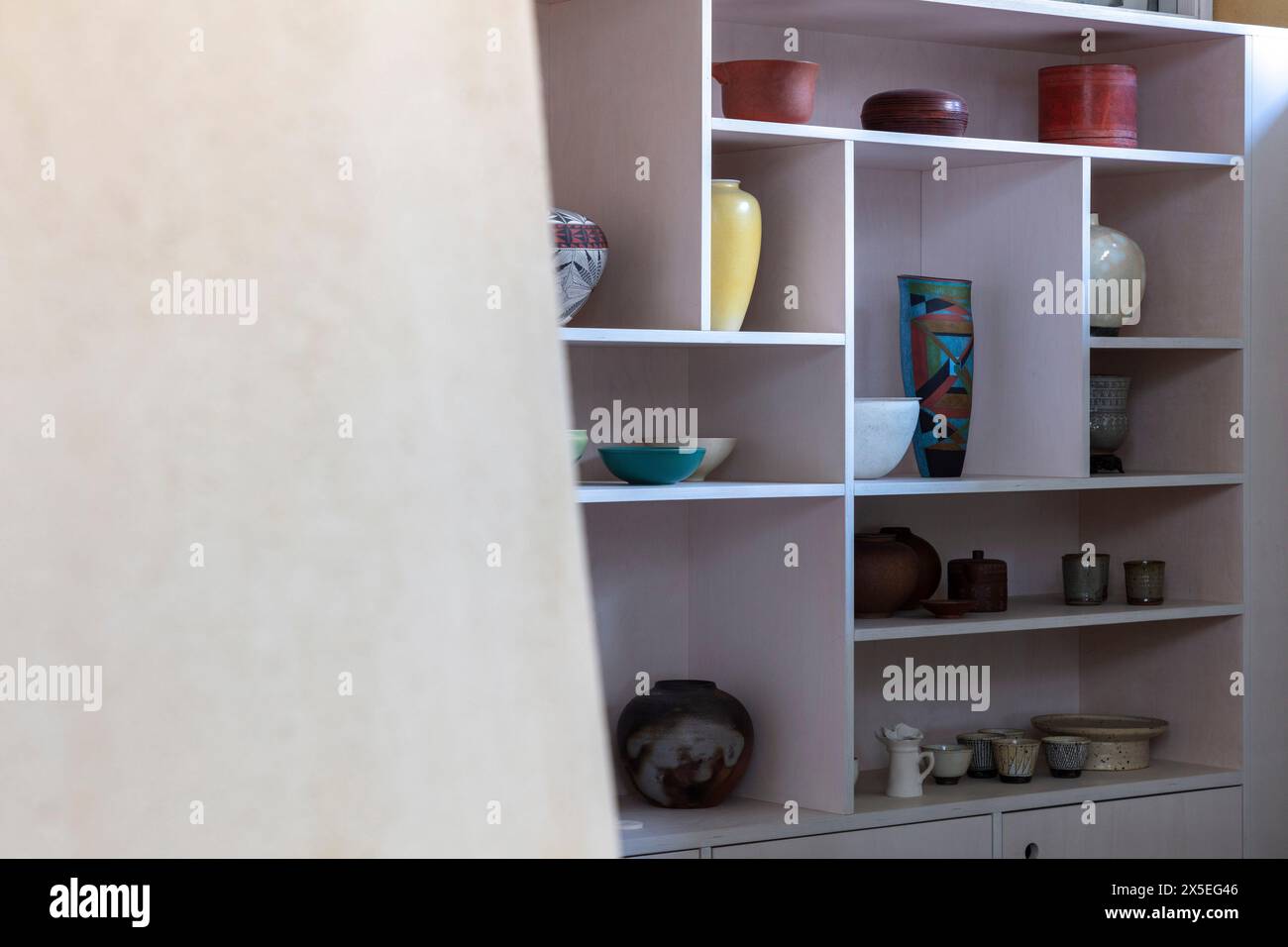 Multishaped custom storage shelves. Straw Bale House, Islington