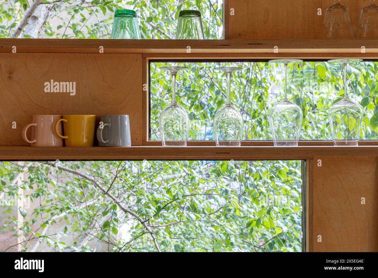 Different shaped windows run down the side of the kitchen area. Straw