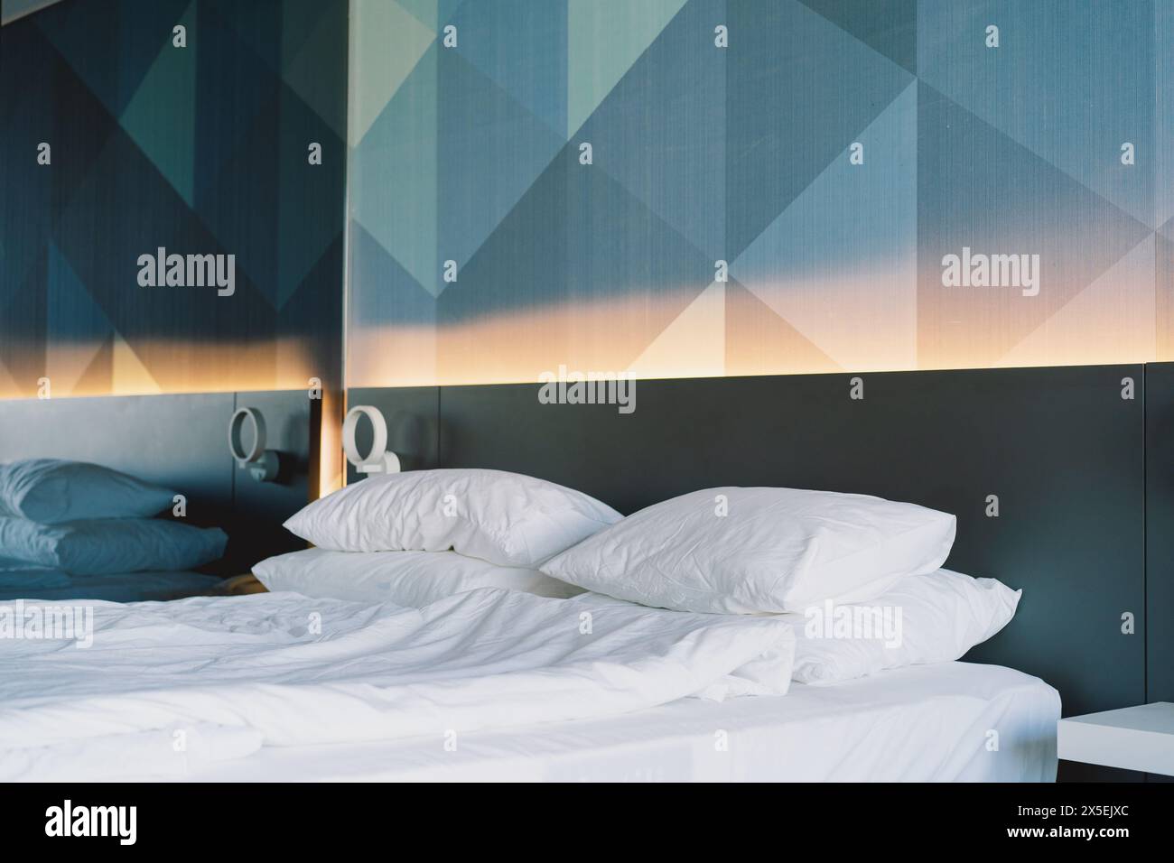 Modern Bedroom Interior With Geometric Wall Design and Unmade Bed Stock ...