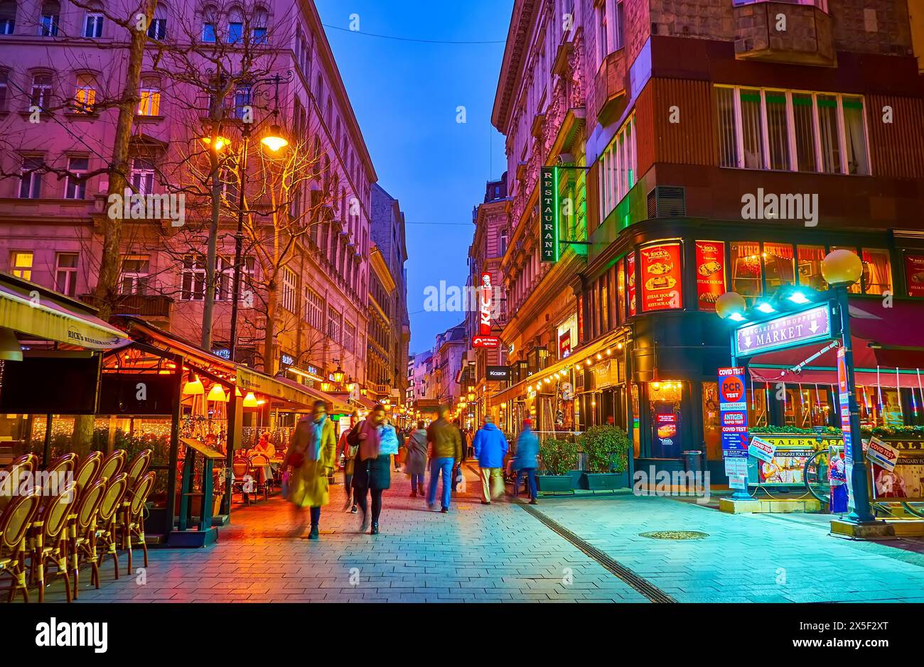 BUDAPEST, HUNGARY - MARCH 3, 2022: Enjoy the evening walk on tourist Vaci Street, famous for its restaurants, cafes, bars and souvenir shops, Budapest Stock Photo