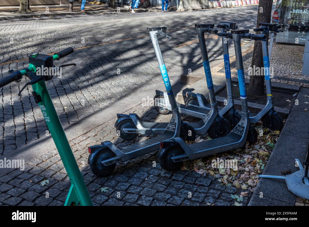 Oporto, Portugal - November 23, 2023: Electric kick scooters or e-scooters rental of the Bolt, Bird or Circ brand and sharing parked on a street in Op Stock Photo