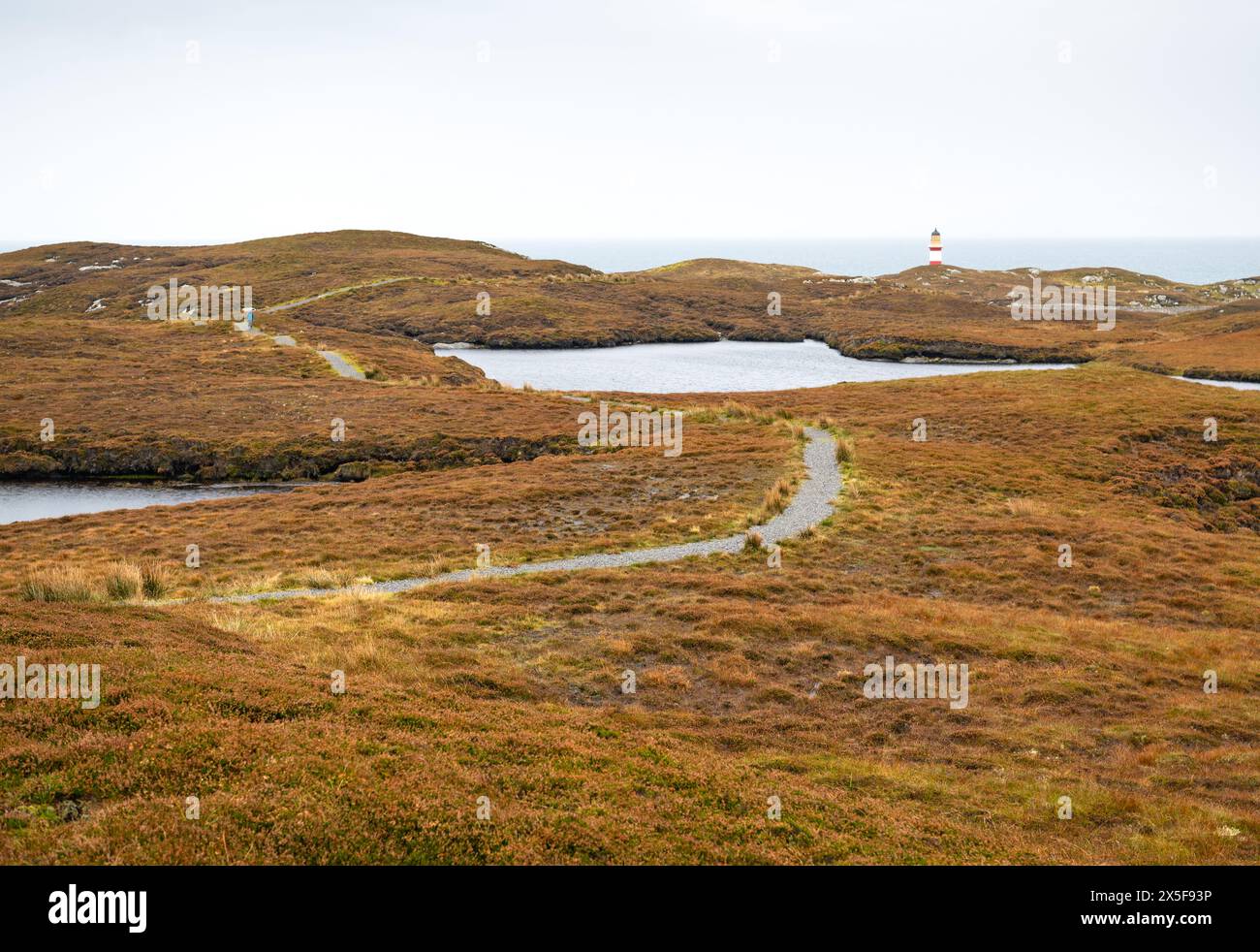 An exposed to weather path through the moorlands towards Eilean Glas Lighthouse on the Isle of Scalpay, Outer Hebrides, Scotland Stock Photo