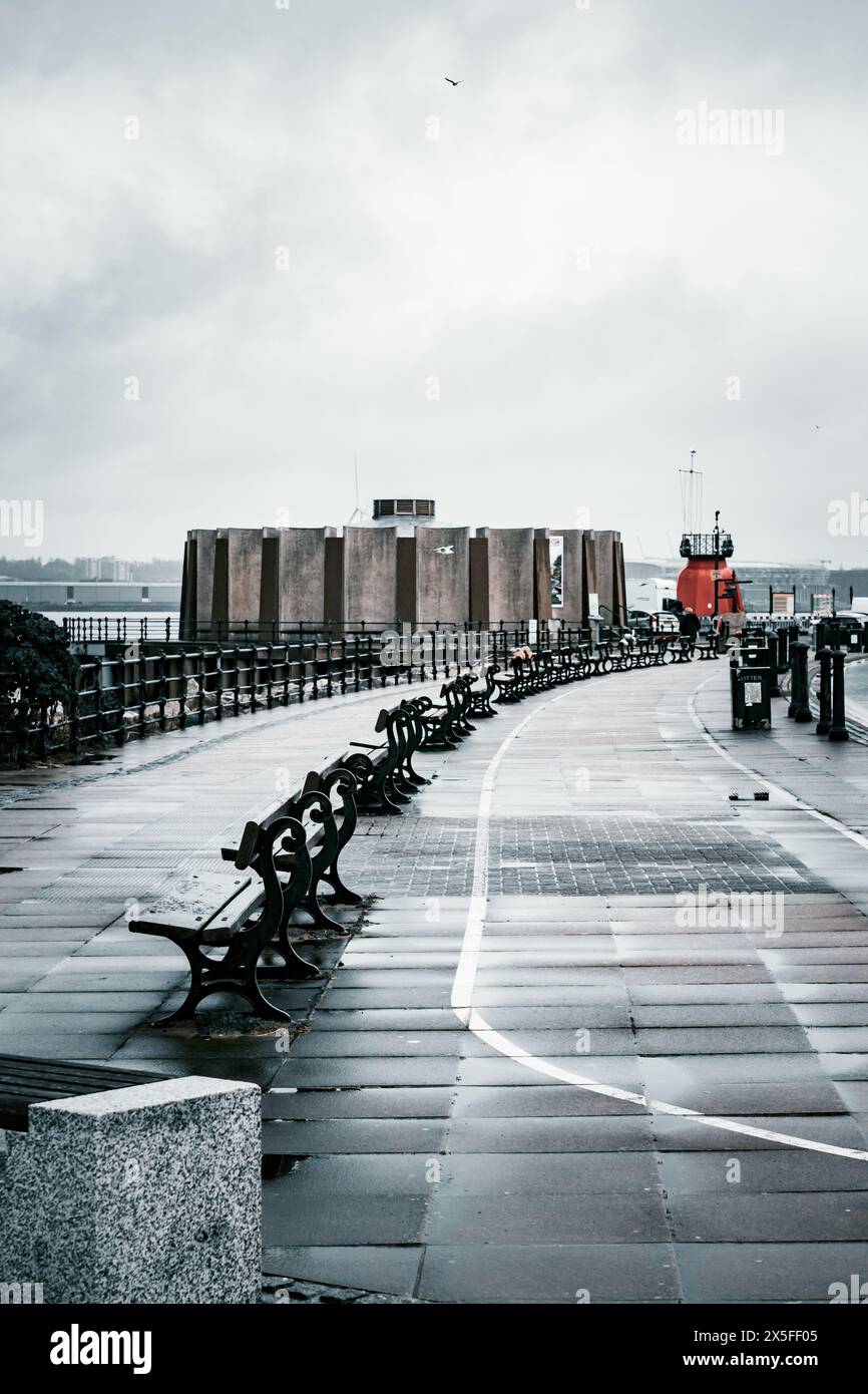 New Brighton Wallasey sea front on a cold winters day with empty park benches Stock Photo