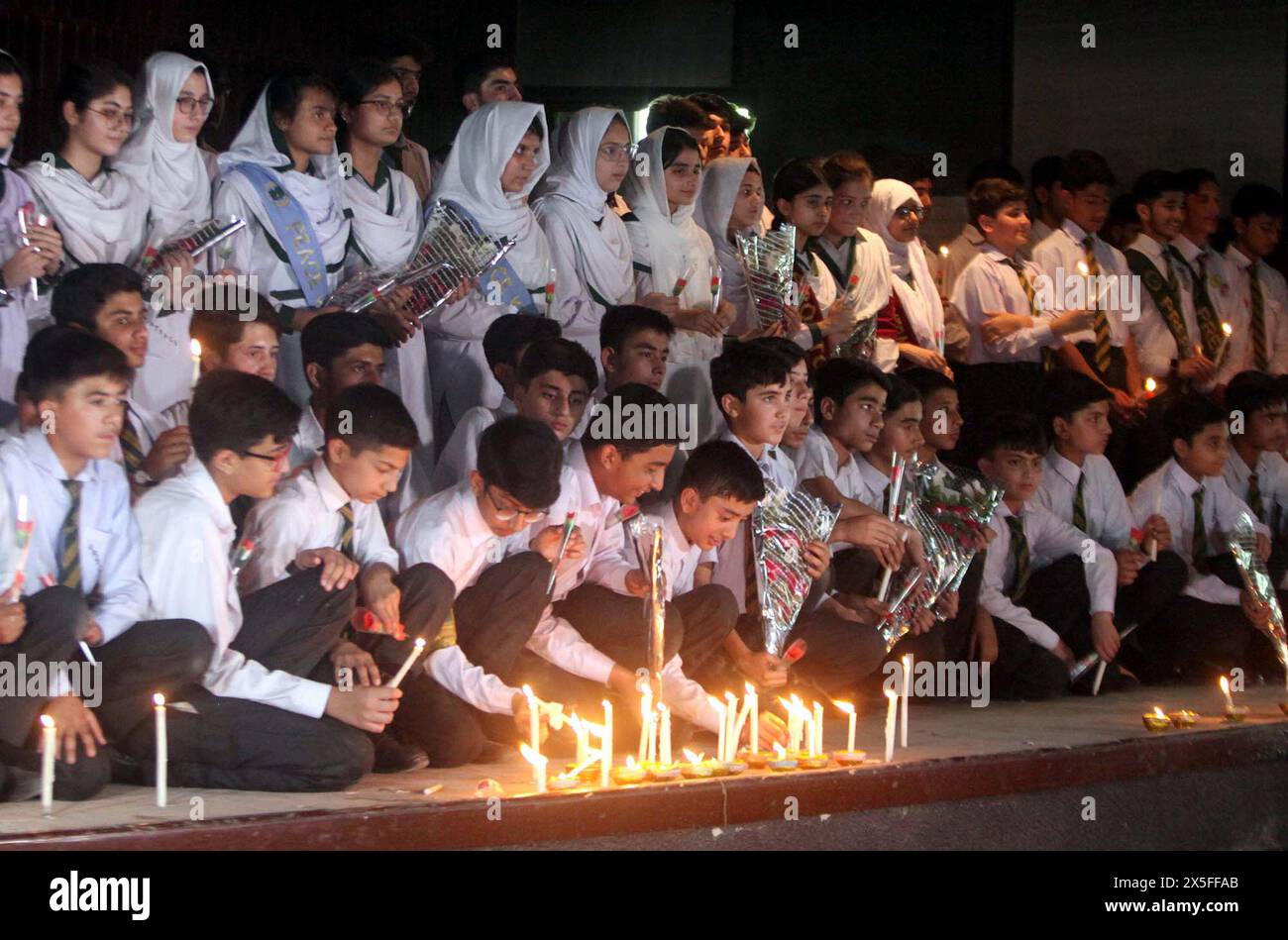 Students from Army Public School (APS) enlightened candles during their visit to Radio Pakistan building which was torched last year in the wake of May 9 riots, in Peshawar on Thursday, May 9, 2024. The government has decided to mark May 9 as black day on Thursday (today) in commemoration of the first anniversary of the violence against military installations throughout the country. Stock Photo