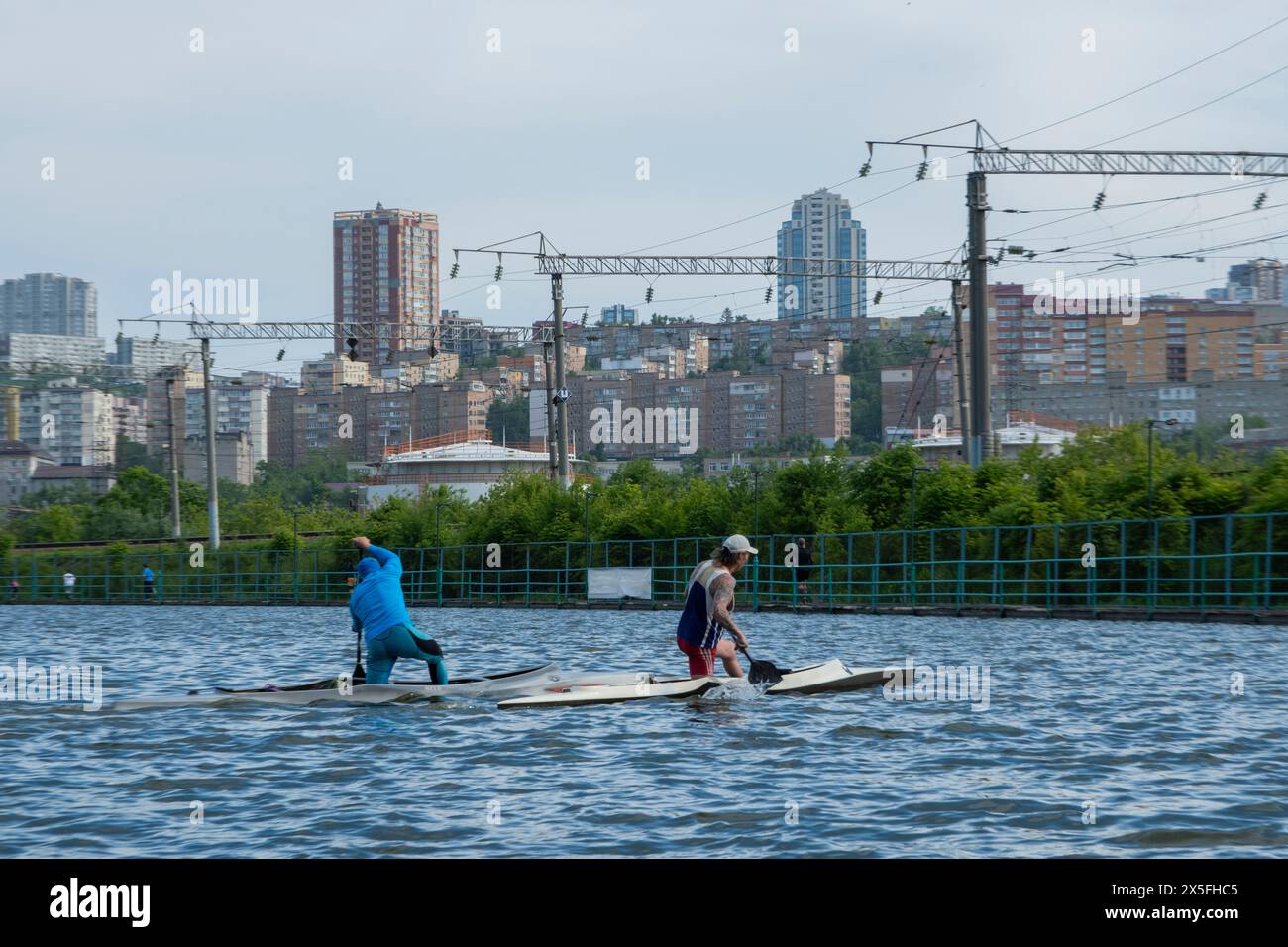 Two men paddling a canoe on a lake. Two friends boating Stock Photo - Alamy