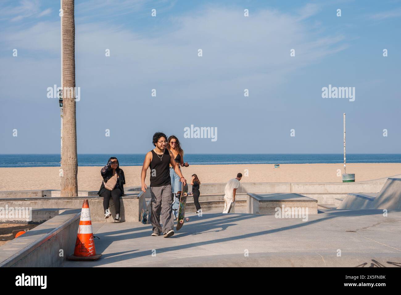 Skatepark Scene with Couple, Beach Vibe, Venice Beach, Los Angeles Stock Photo