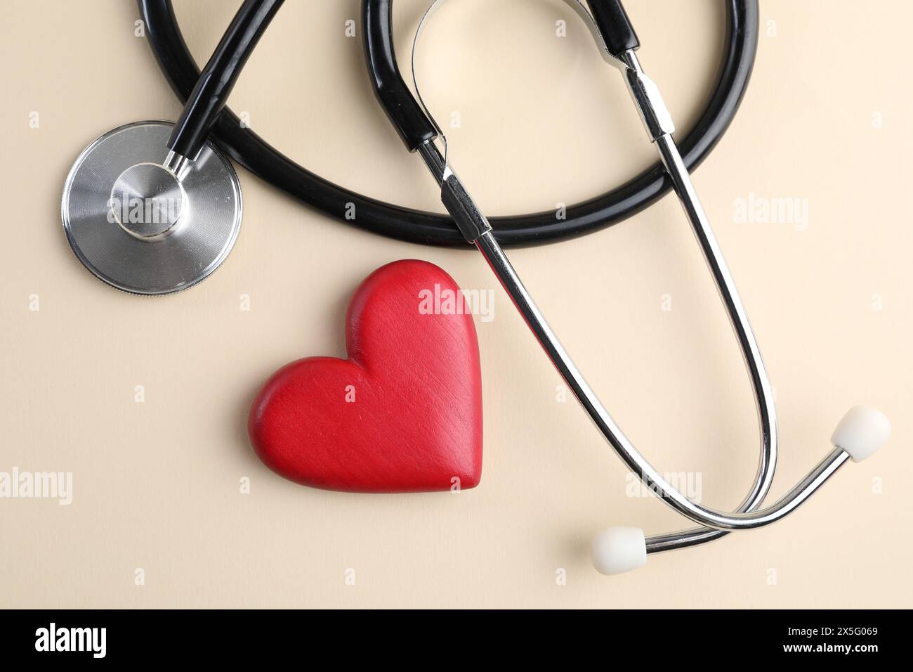 Stethoscope and red heart on beige background, top view Stock Photo - Alamy