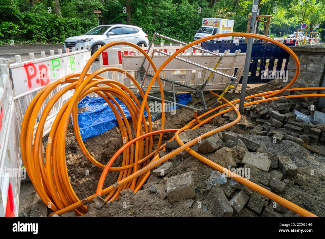 Laying of fiber optic cables, empty conduits are laid under a sidewalk