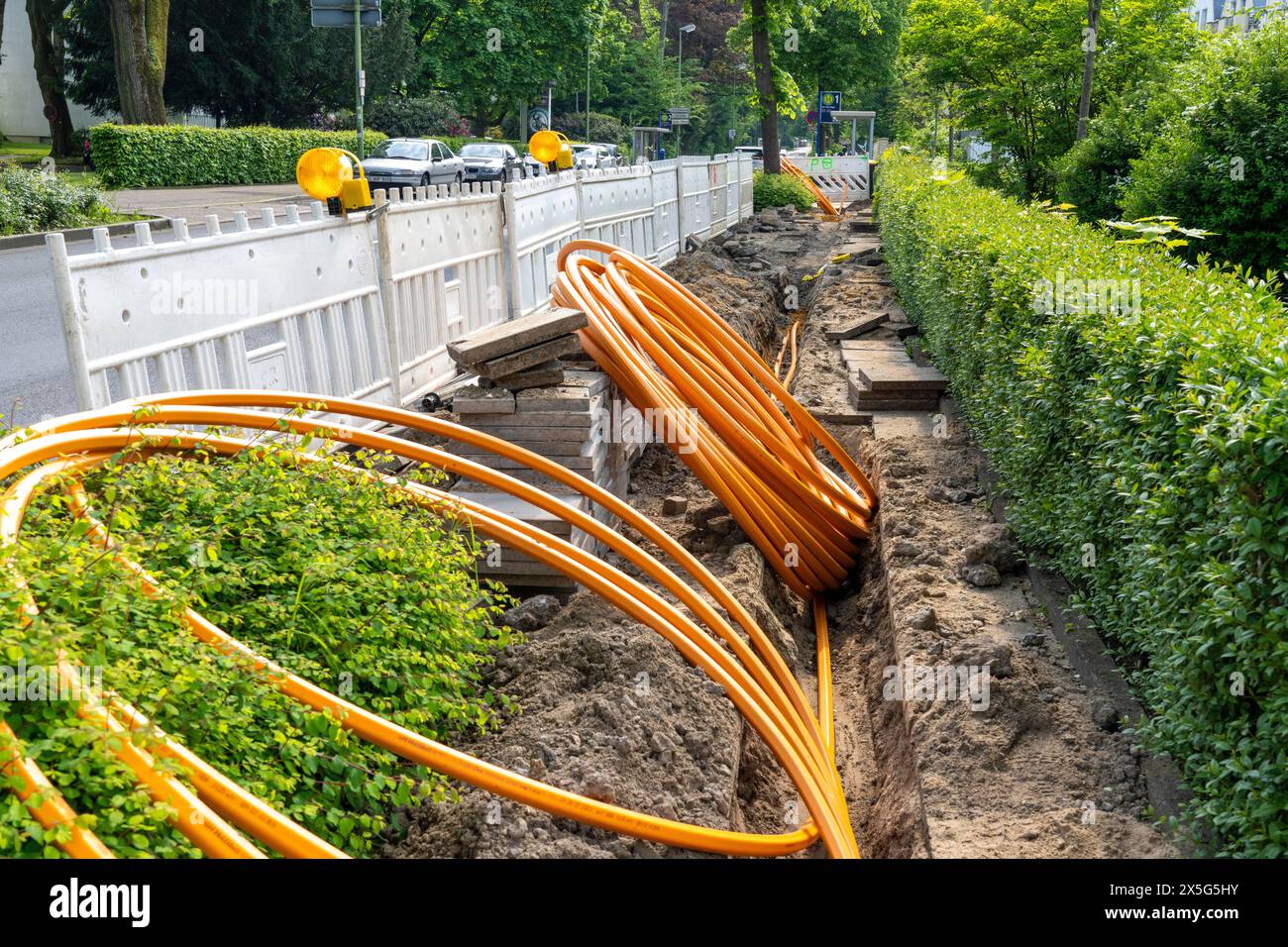 Laying of fiber optic cables, empty conduits are laid under a sidewalk