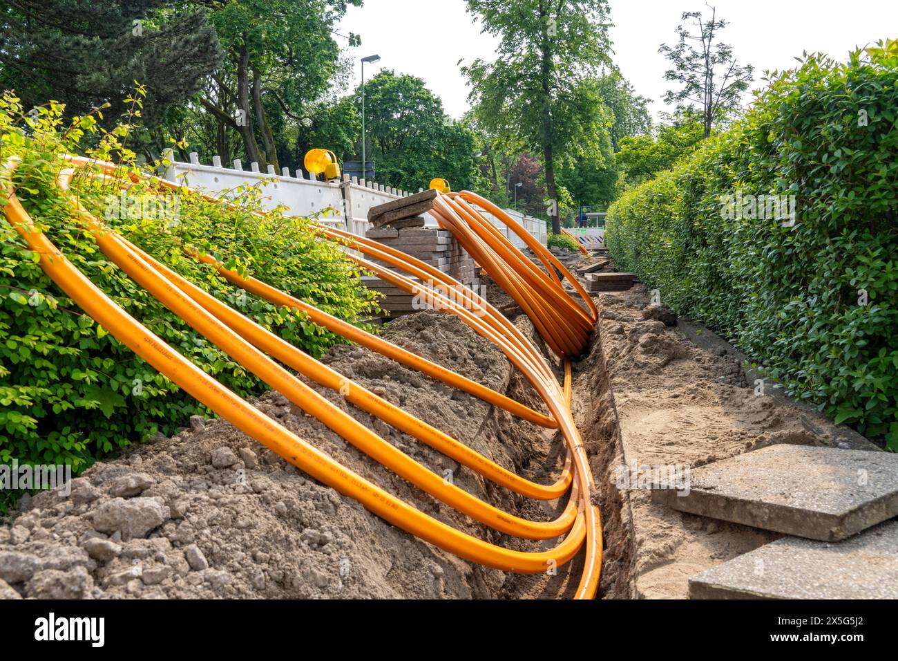 Laying of fiber optic cables, empty conduits are laid under a sidewalk
