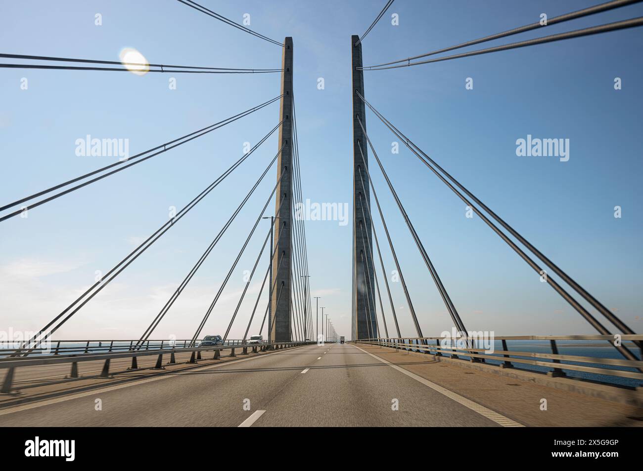 Steel wires from the pylons on the Øresund Bridge form a pattern across the roadway between Malmö and Copenhagen Stock Photo