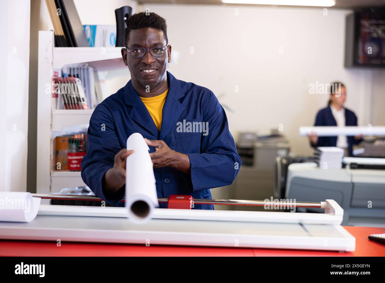 Portrait positive of man printshop worker with plotter paper roll Stock ...