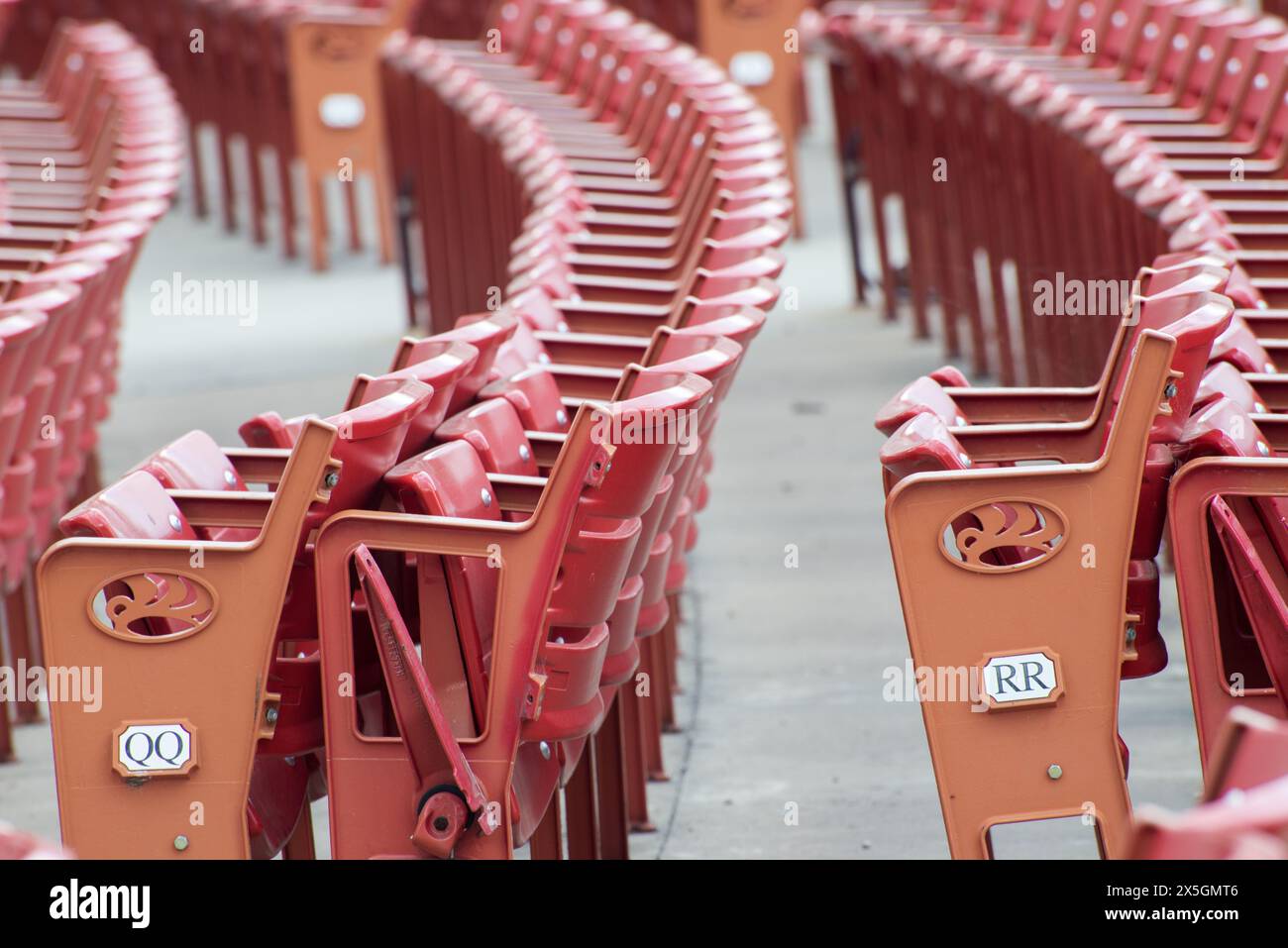 A row of red seats with wooden handles Stock Photo