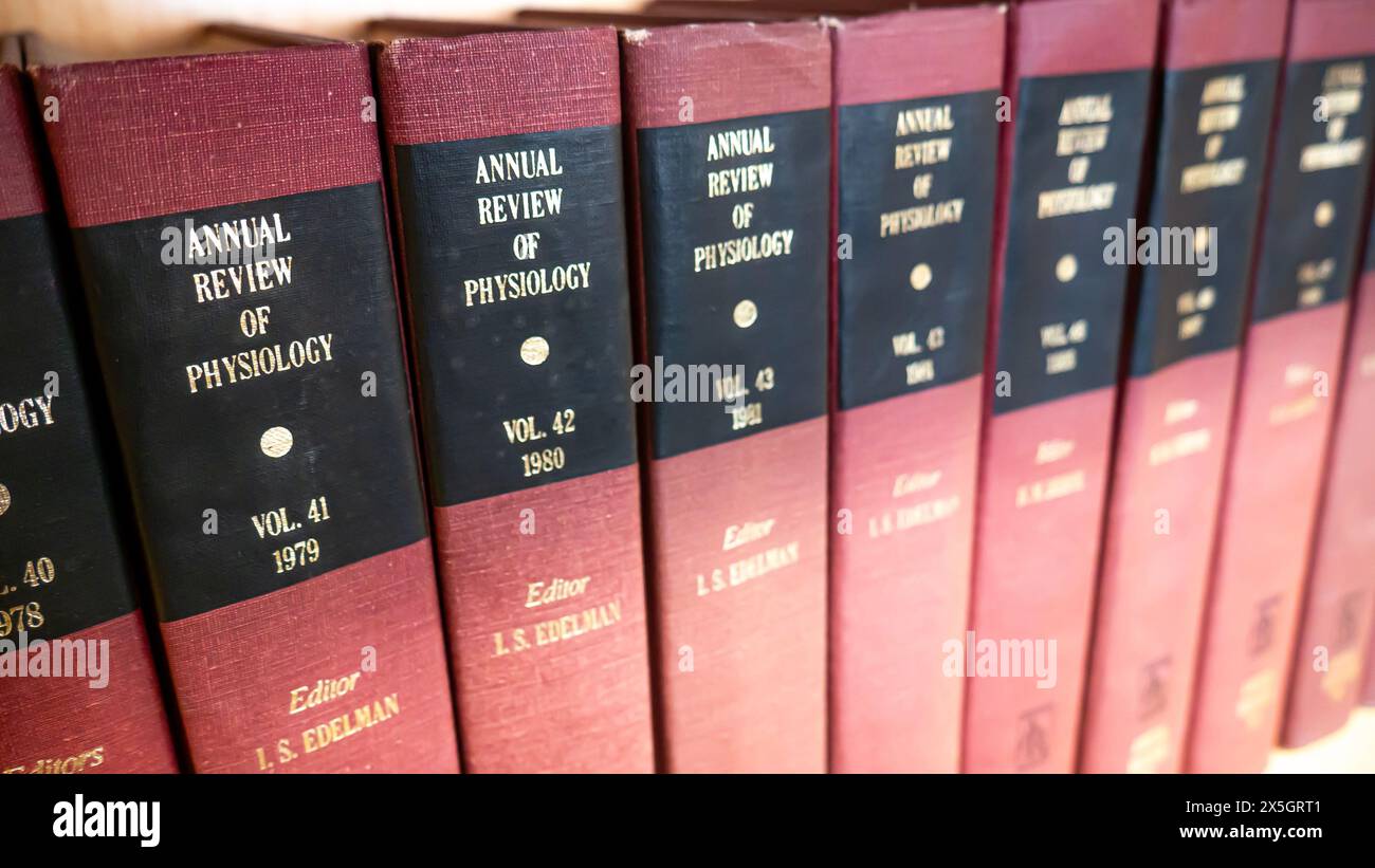Annual Review of Physiology, bound physiology journals stacked on a university library bookshelf Stock Photo