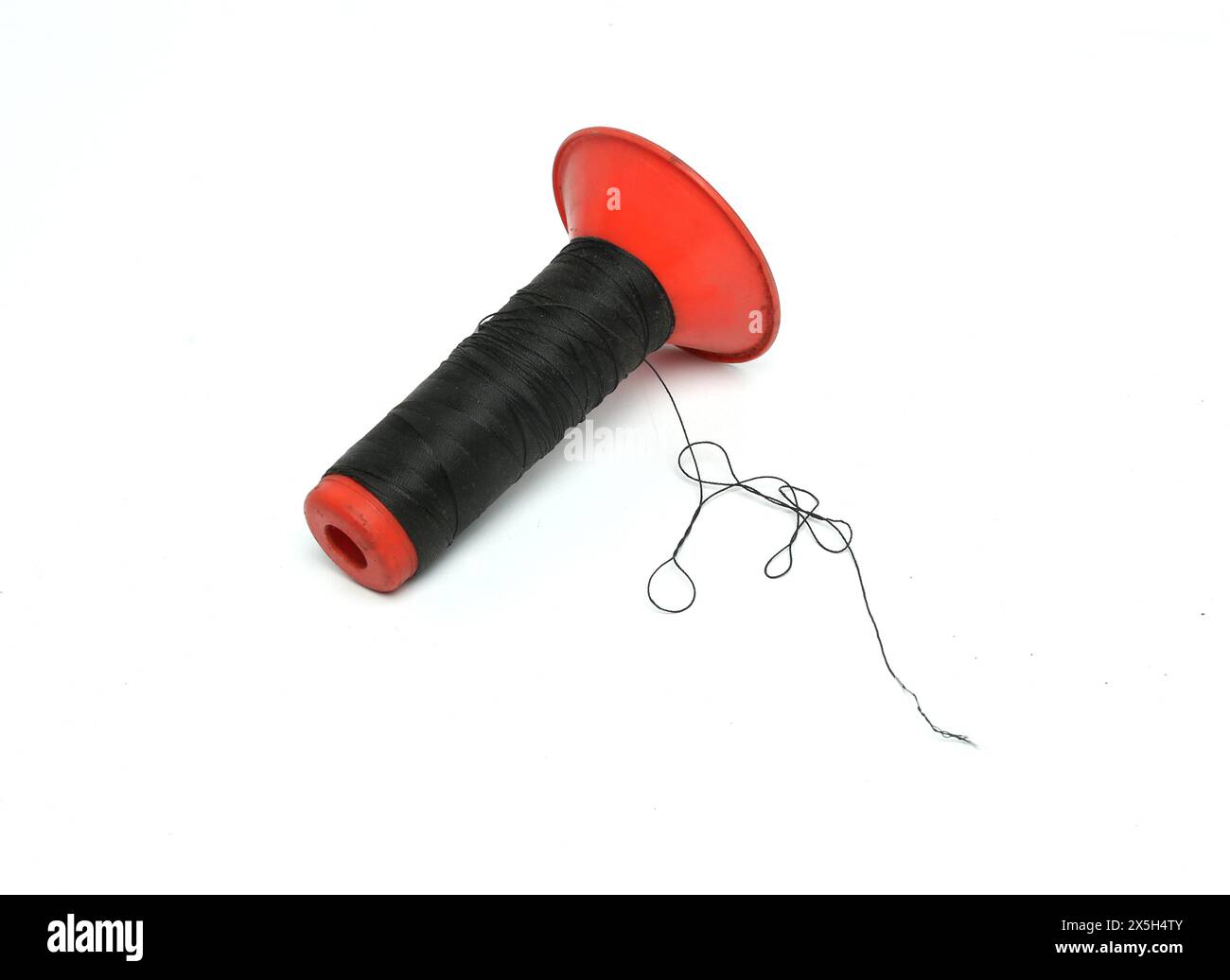 black thread roll isolated on white background Stock Photo - Alamy