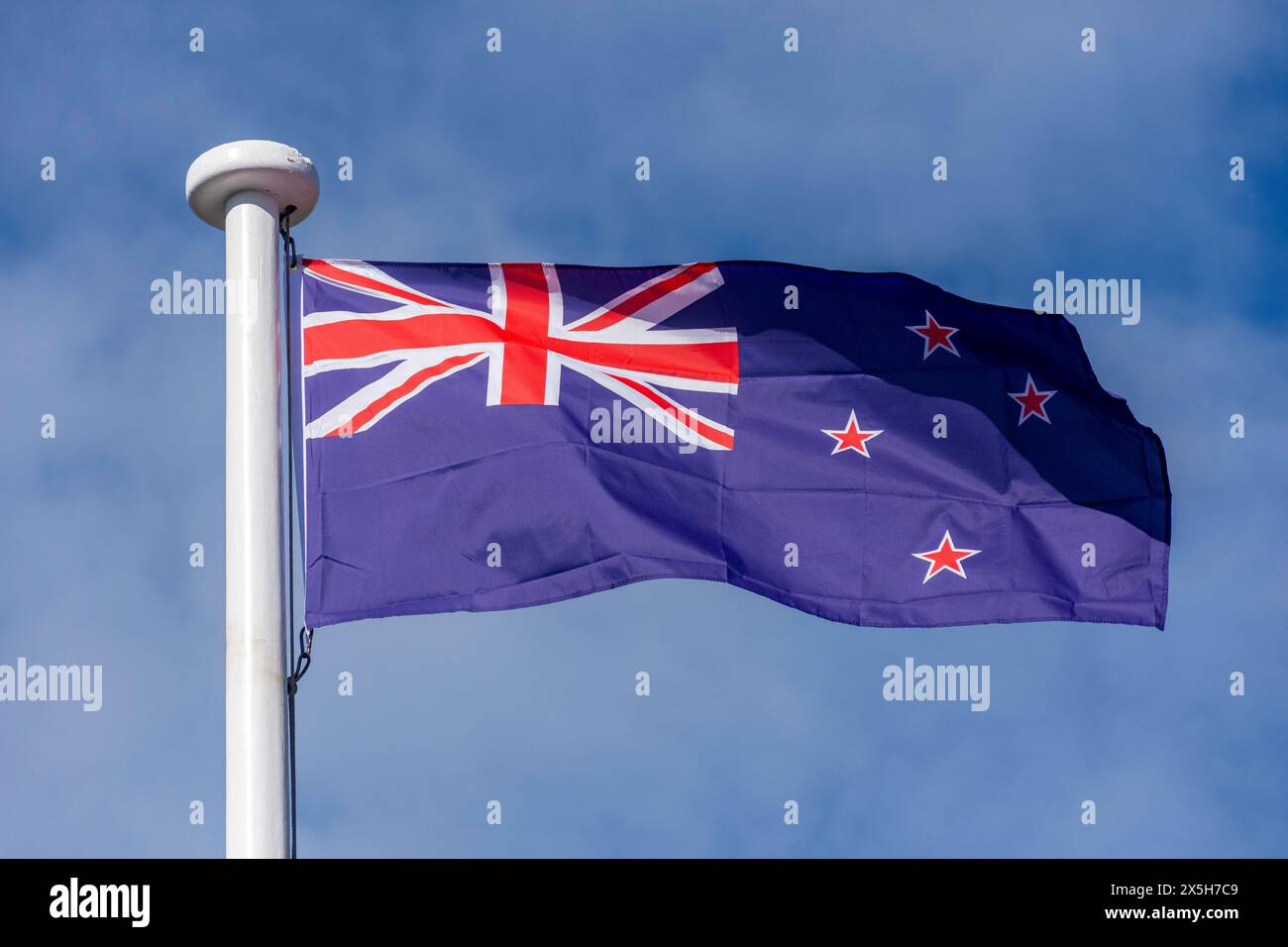 New Zealand flag on flagpole, Main Road, Methven, Canterbury, South Island, New Zealand Stock Photo