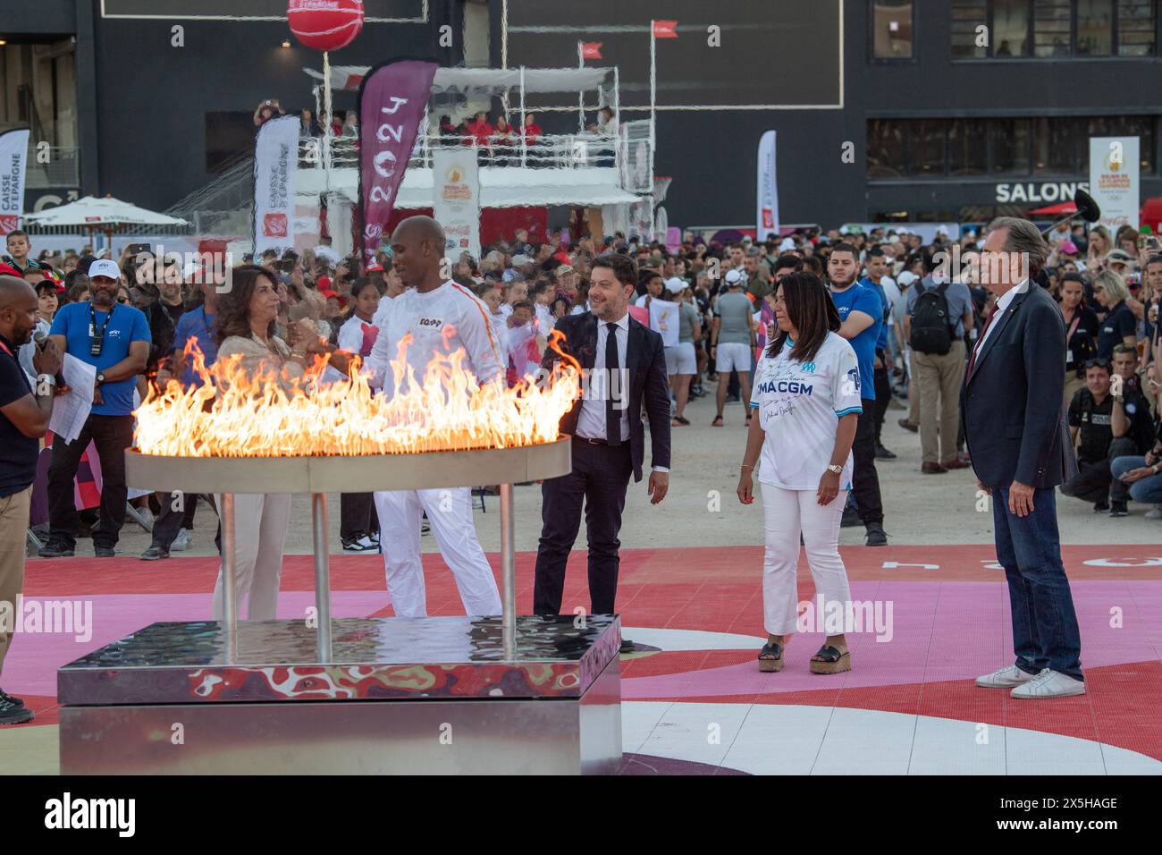 Marseille, France. 09th May, 2024. French Ivorian former football player Didier Drogba holds the Olympic Torch as part of the Olympic and Paralympic Torch Relays in front of the Stade Velodrome, ahead of the Paris 2024 Olympic and Paralympic Games, in Marseille, southeastern France, on May 9, 2024. The transfer of the flame onshore from a 19th-century tall ship will mark the start of a 12,000-kilometre (7,500-mile) torch relay across mainland France and the country's far-flung overseas territories. Phot boy Laurent Coust/ABACAPRESS.COM Credit: Abaca Press/Alamy Live News Stock Photo