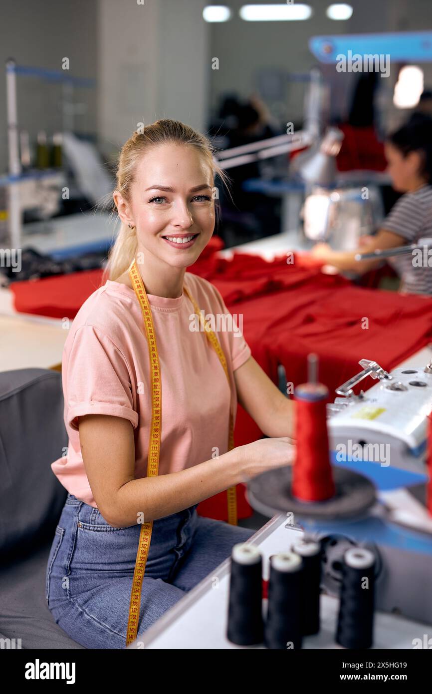 Textile cloth factory working process tailoring modern clothes, young