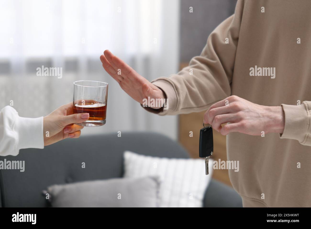 Driver with car keys refusing alcohol, closeup. Don't drink and drive ...
