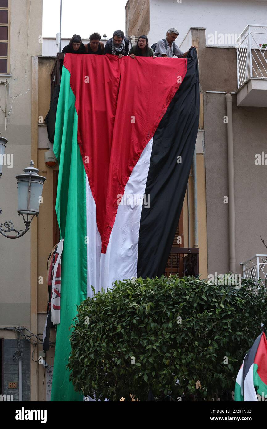 in the photo the pro-Palestine flag is lowered on the facade of the Felicia and Peppino Impastato memorial house Stock Photo