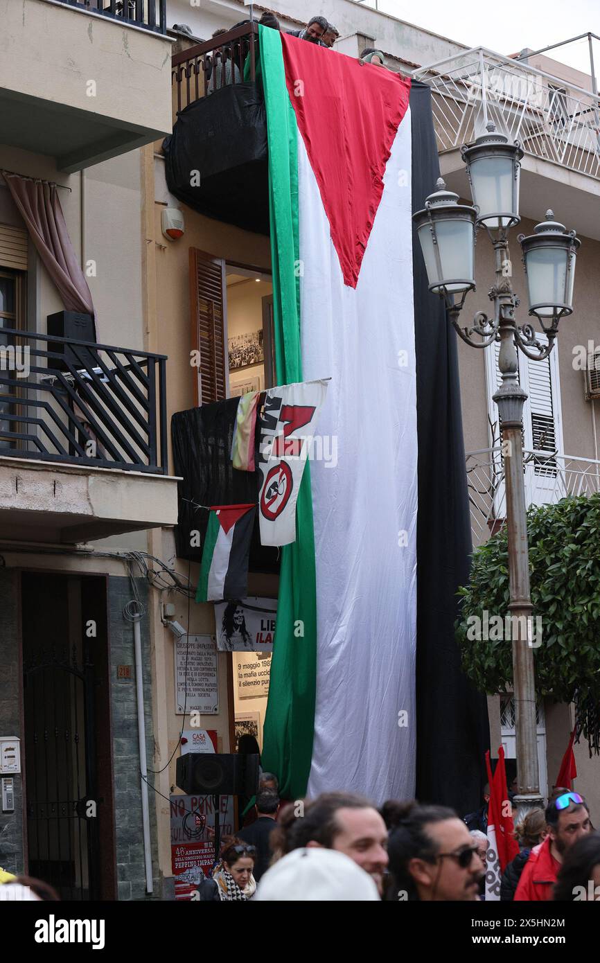 in the photo the pro-Palestine flag is lowered on the facade of the Felicia and Peppino Impastato memorial house Stock Photo