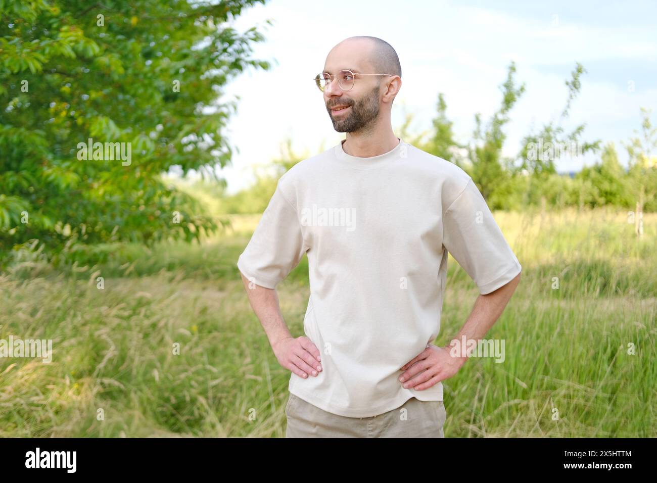 young 30-year-old serious man Outdoors in nature, Subtle Smile on Lips, Psychology and Impact, Seriousness and Determination, Mental Health in Third D Stock Photo