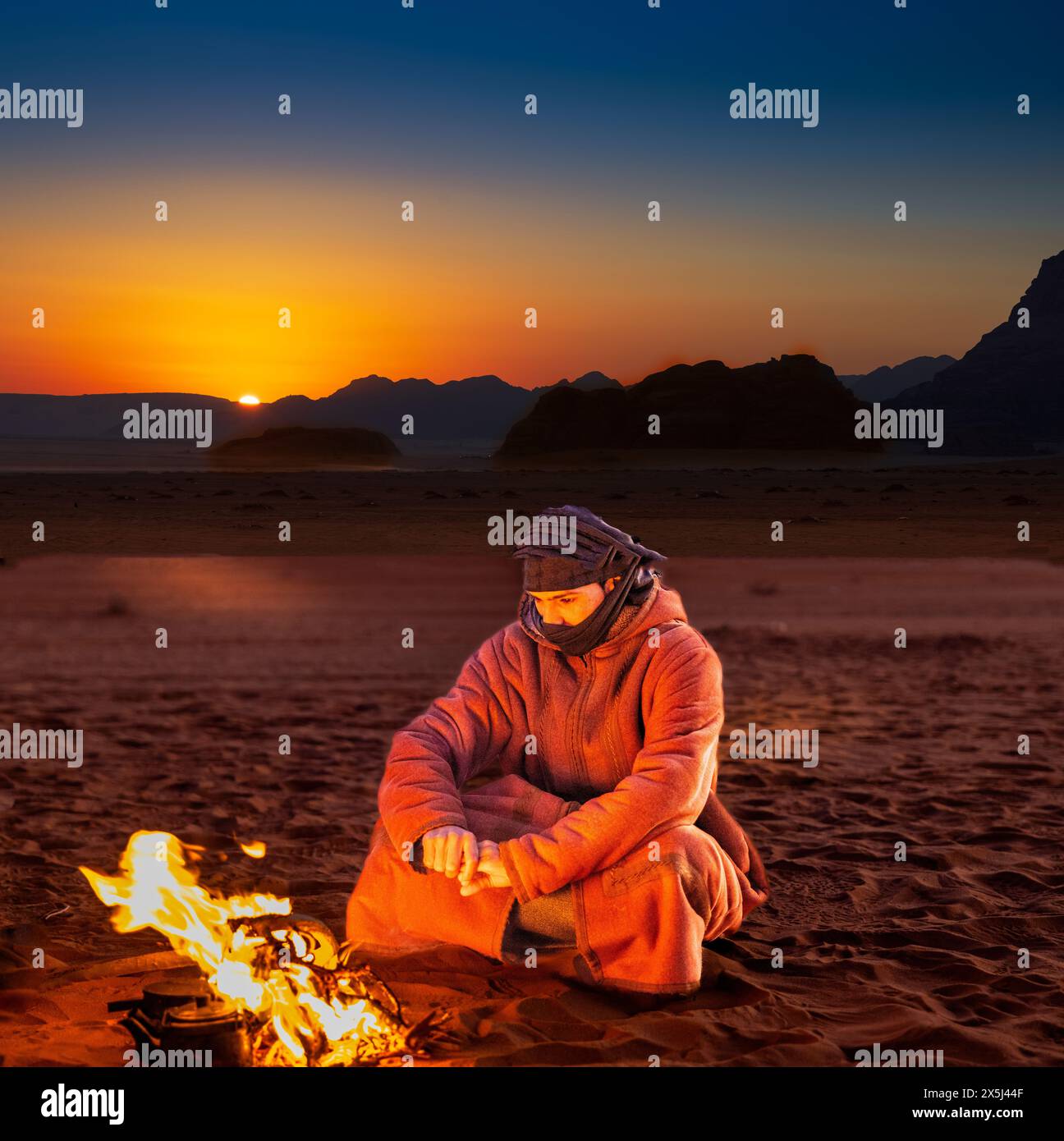 Jordan, Wadi Rum. Valley of the Moon Bedouin starts fire to keep warm ...