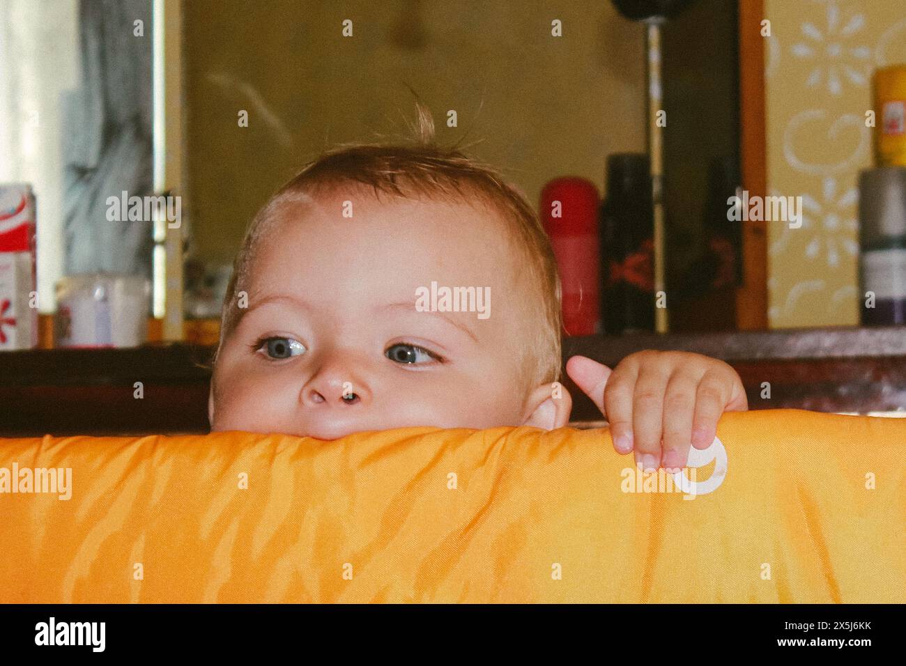 small child climbs out of crib Stock Photo