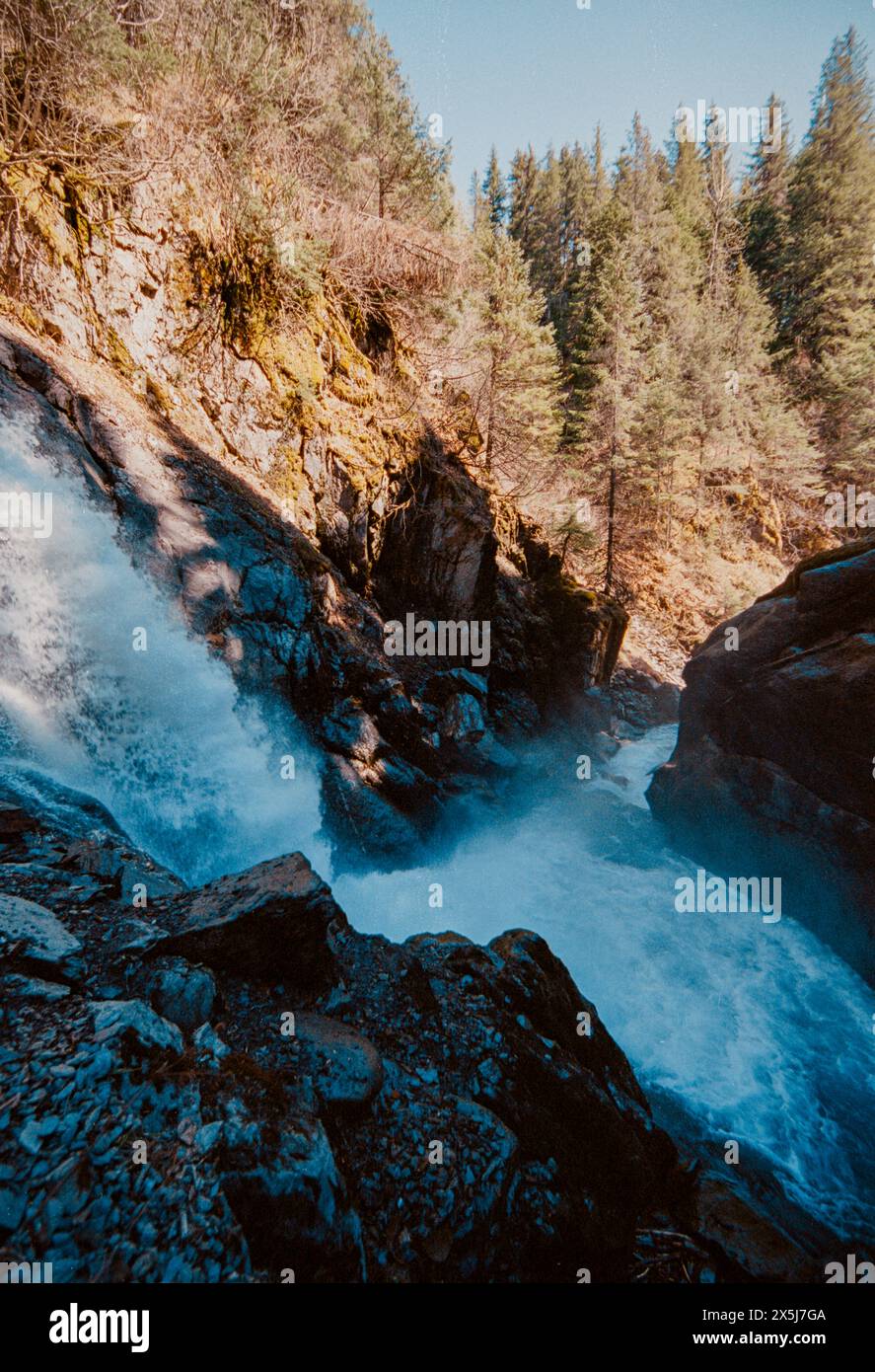 A waterfall rushes down a mountain in isolated Alaska Stock Photo - Alamy