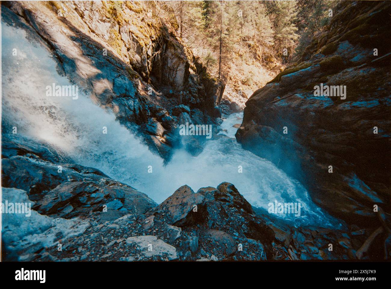 A waterfall rushes down a mountain in isolated Alaska Stock Photo - Alamy