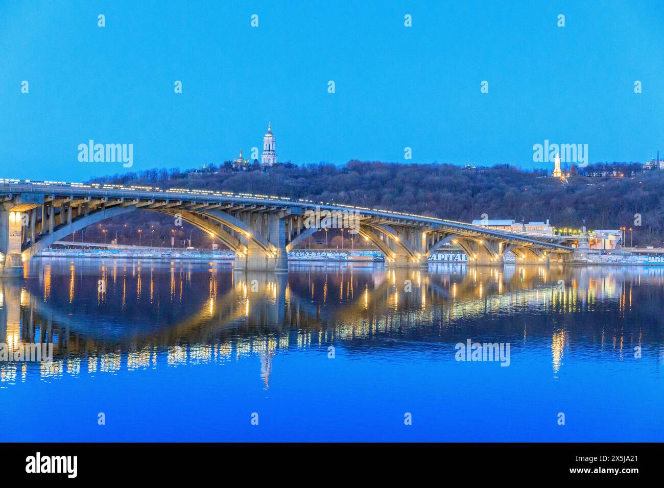 Ukraine, Kiev, Kyiv. Metro Bridge across the Dnieper River. Roofs of Monastery of the Caves (Pechersk Lavra) in the background. Stock Photo