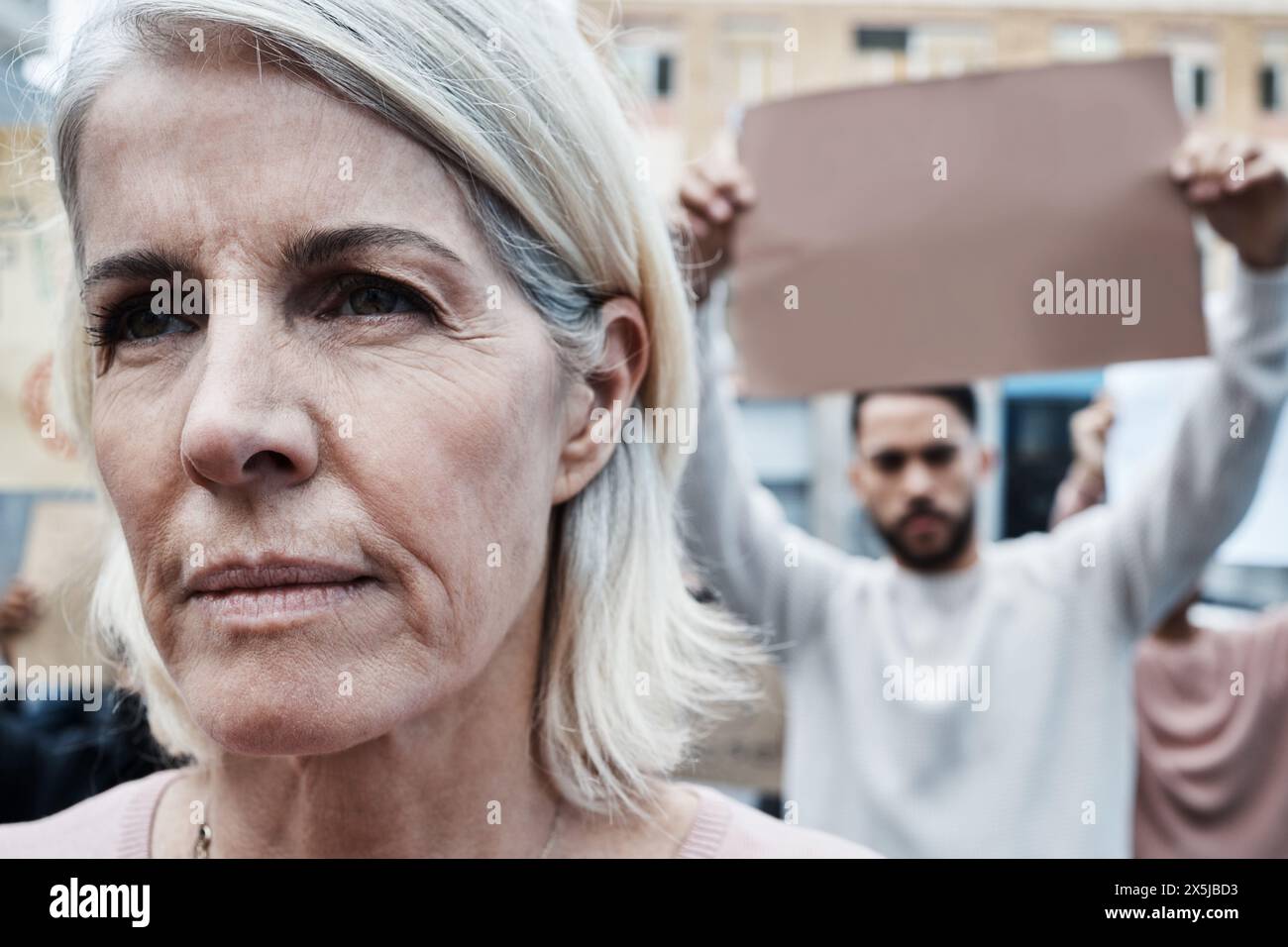 March, street and senior woman in city with protest for life extension drugs ban in society. Community, people and serious female person at rally for Stock Photo