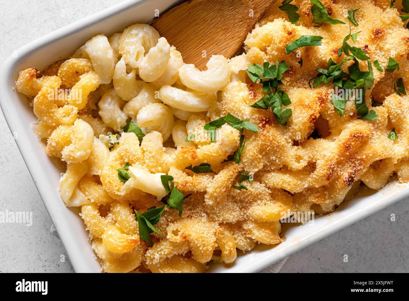 Mac and cheese with breadcrumbs oven baked close up. Traditional ...