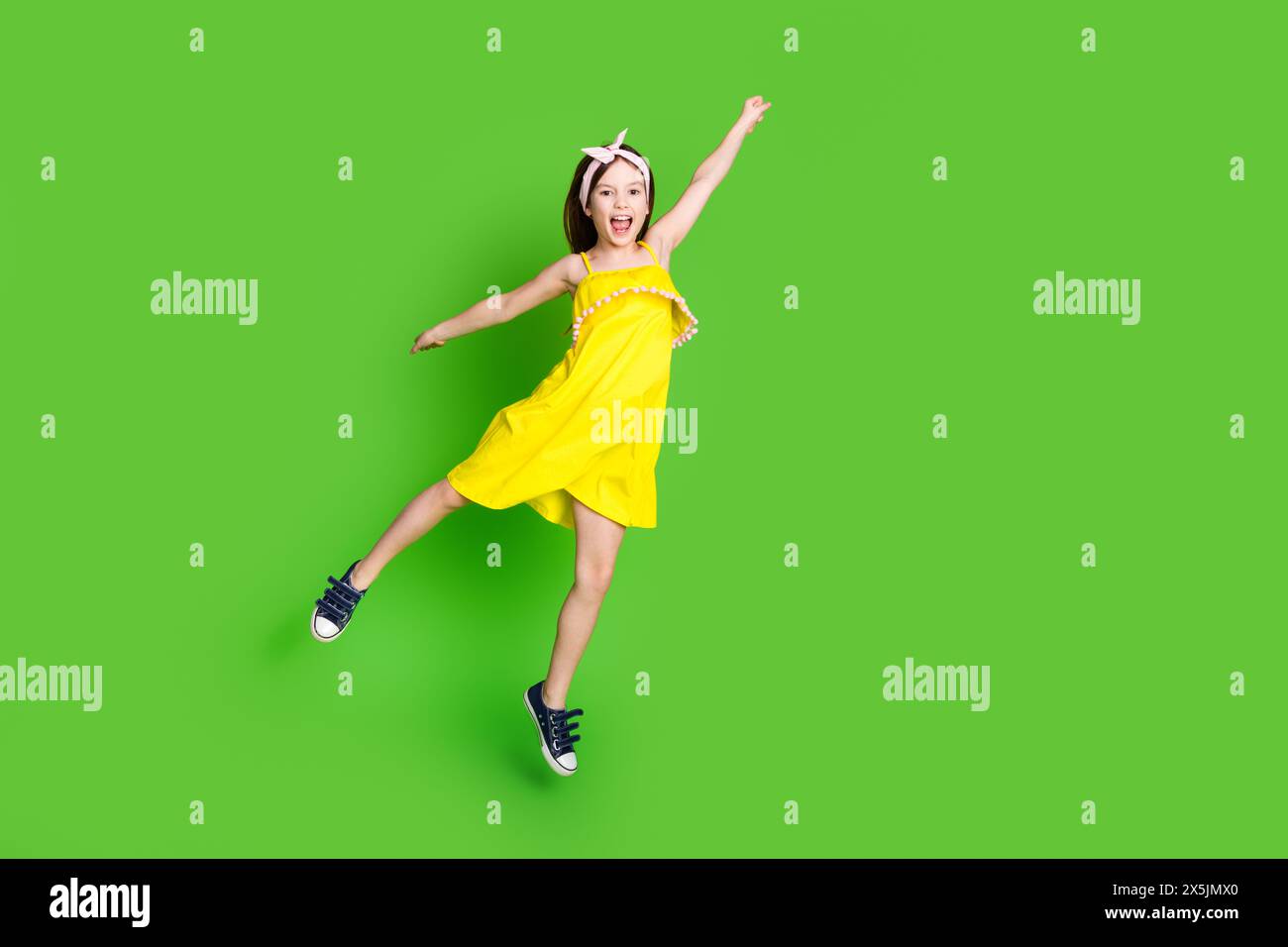 Full length photo of charming cute small girl wear yellow dress jumping ...