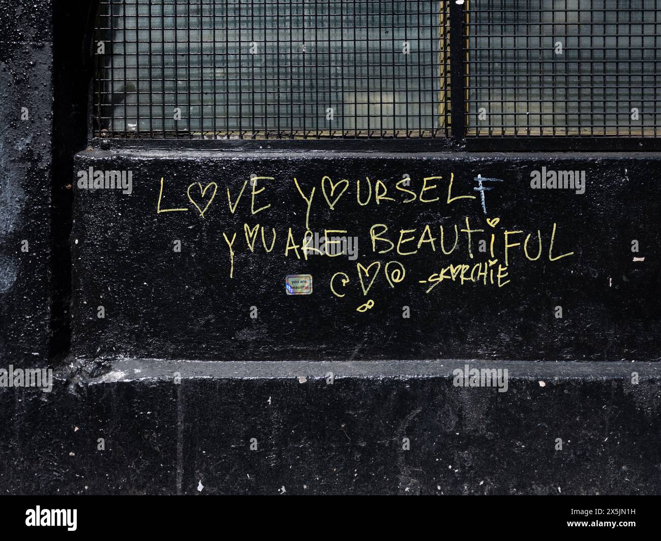 Grafitti on wall in Dublin city, Ireland reading ' Love youself, you are beautiful'. Stock Photo