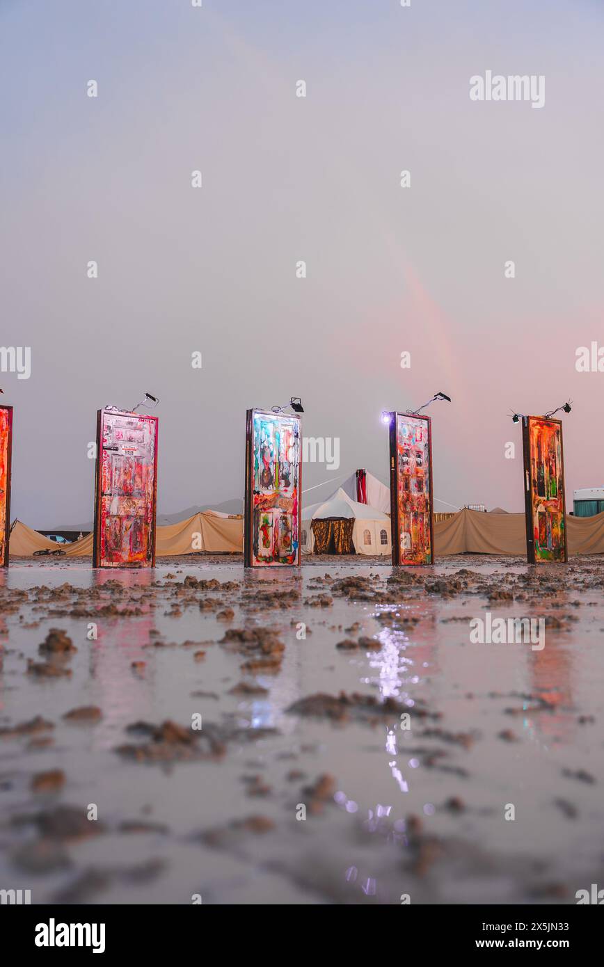 Vibrant Desert Festival Scene with Colorful Art Banners and Tents at Twilight Stock Photo