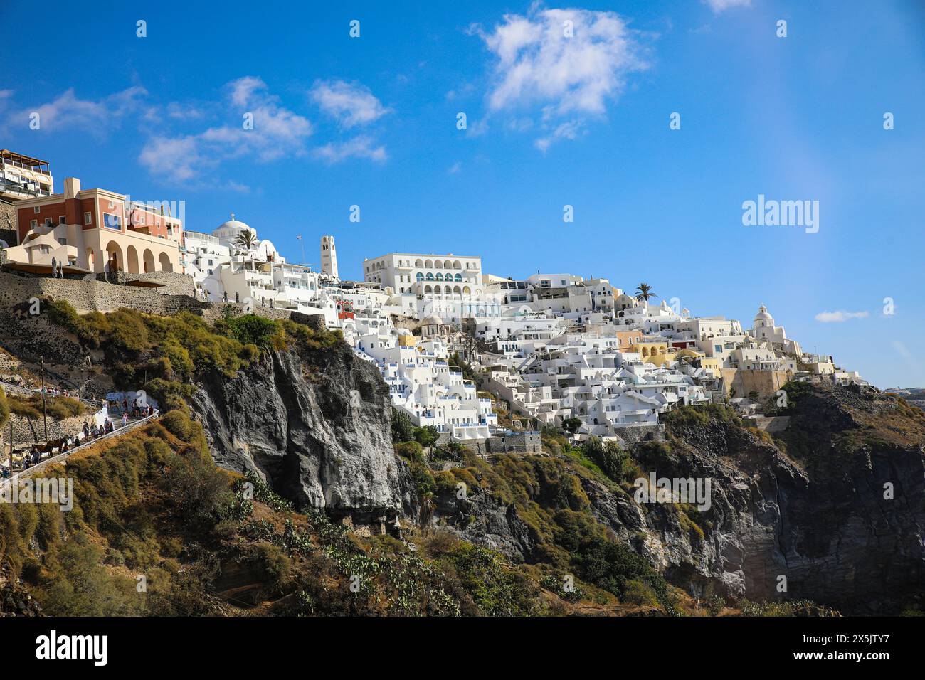 Santorini, Greece, Thira. Donkey trail and scenic view of Thira, Greek domed churches and white washed buildings on the caldera Stock Photo