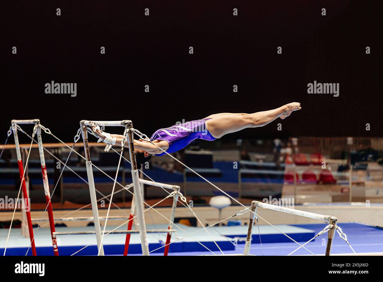 woman gymnast exercise on uneven bars gymnastics on black background Stock Photo Alamy