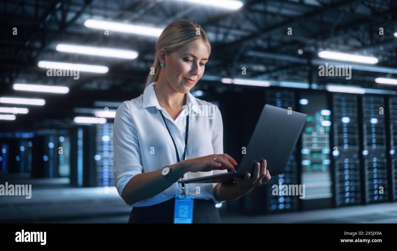 Businesswoman Working with Laptop Computer in Her Office. Skilful Female CEO Runs Business Company During the Evening. Cloud Service, Server Transfer and Analytics concept Stock Photo