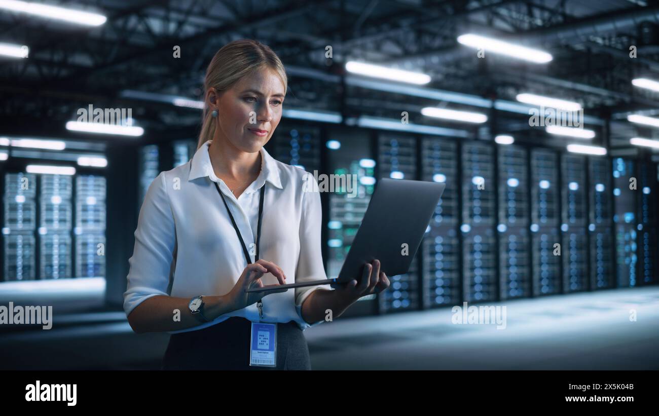 Server Room Specialist Facility with Caucasian Woman System Administrator Working with Data Protection Network. Female Data Center Engineer Using Laptop Computer at the Night Office Stock Photo - Alamy