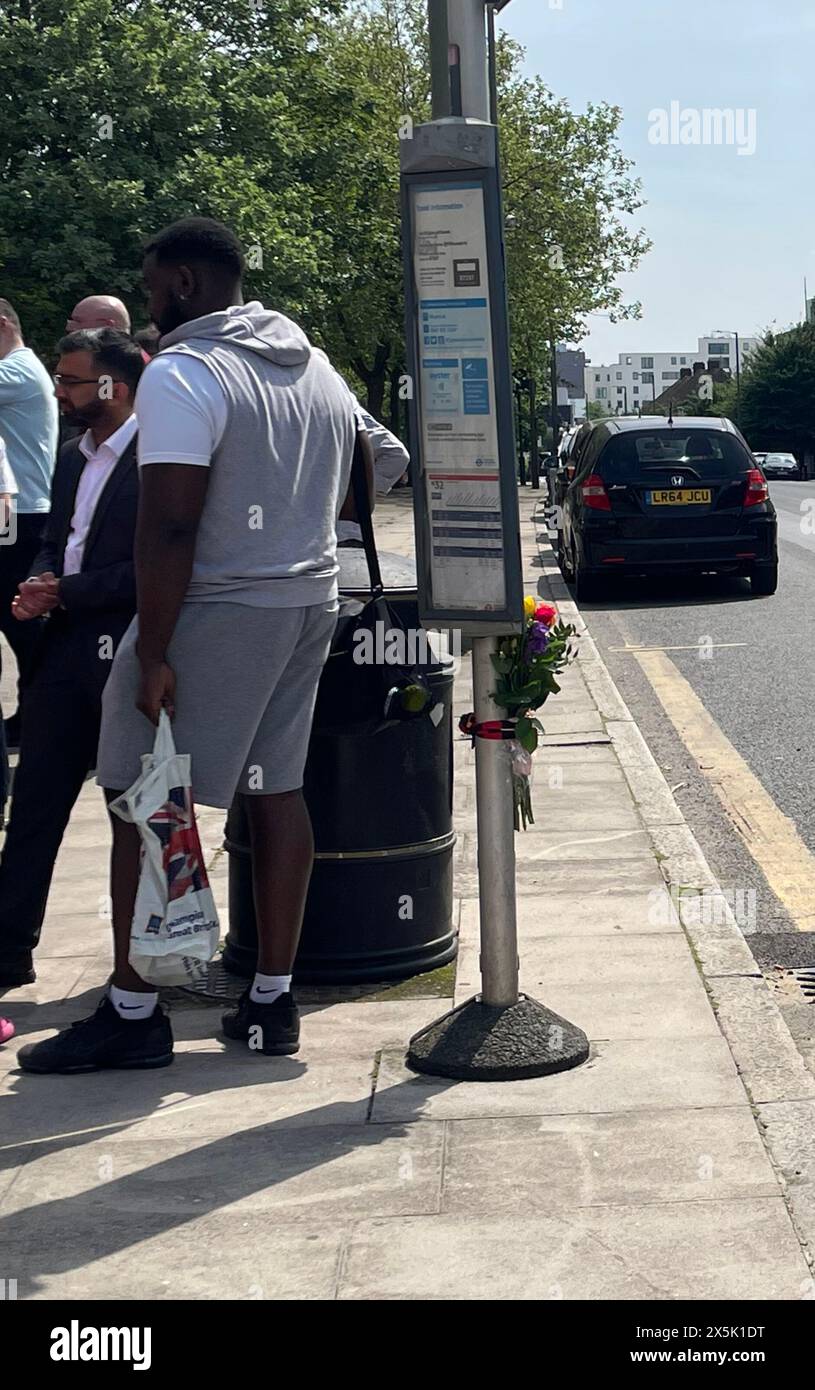 Flowers left at a bus stop near to the scene where a woman in her 60s ...