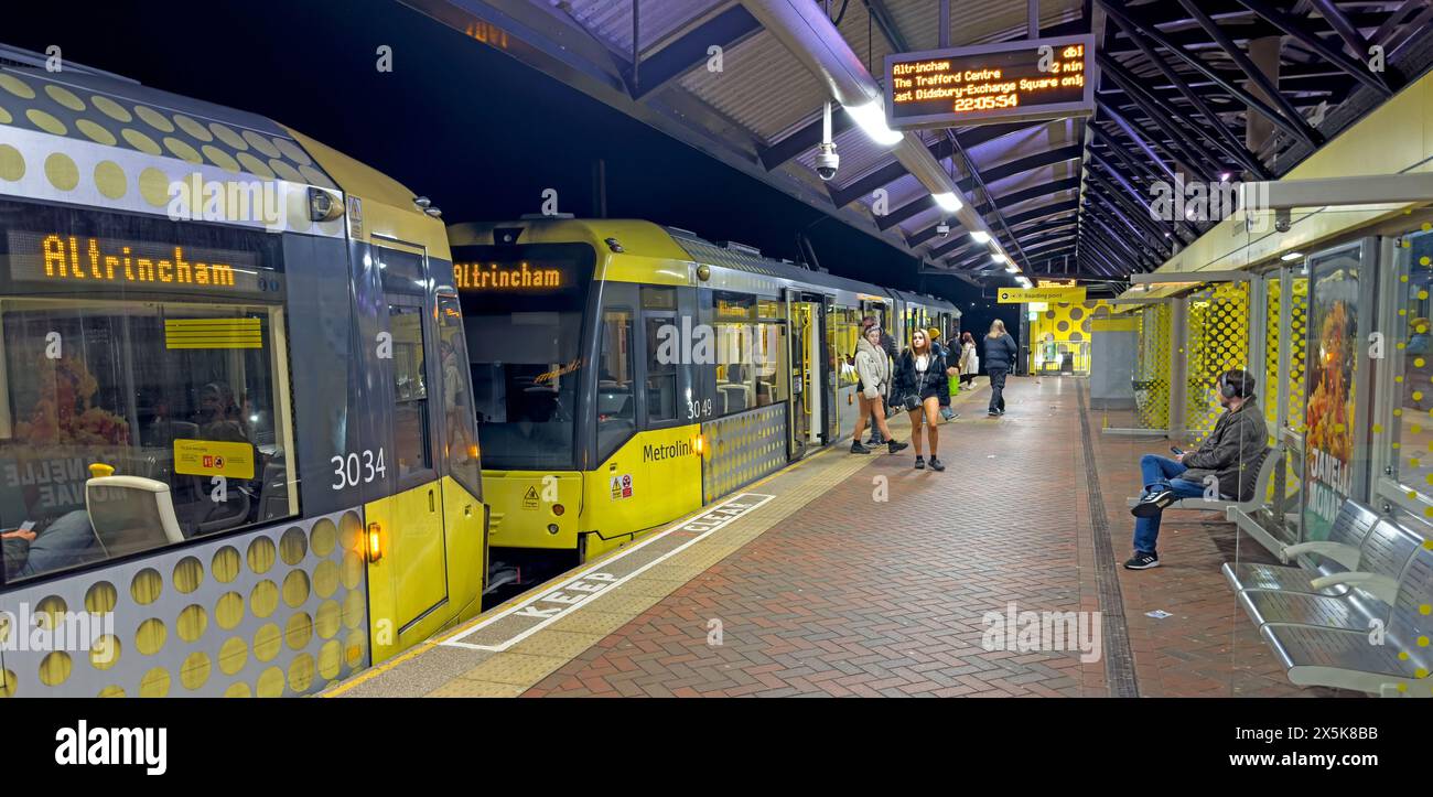 Metrolink Altrincham Manchester double tram, at Cornbrook station tramstop at night, Stock Photo