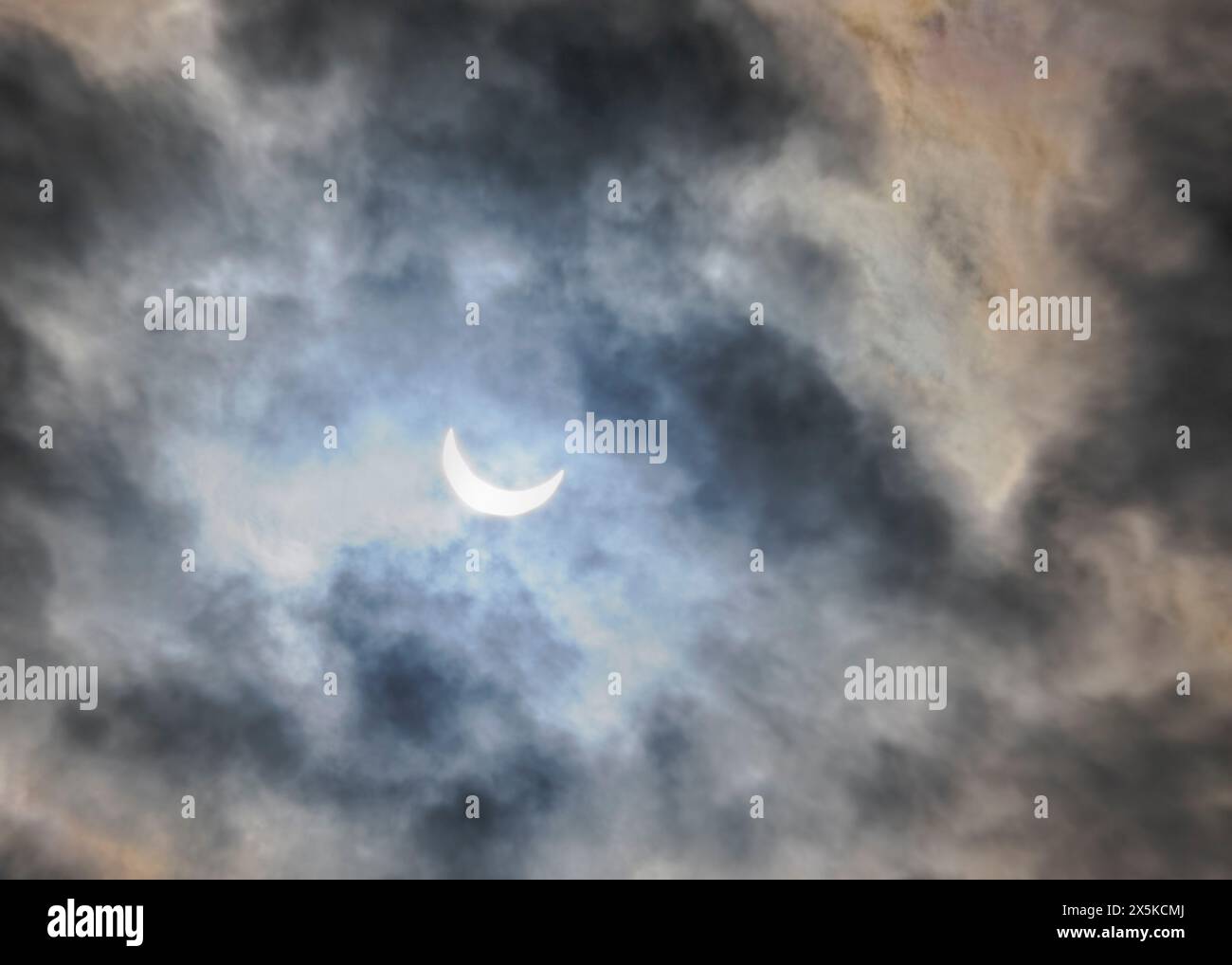 Solar Eclipse with dark blue sky and clouds Stock Photo - Alamy
