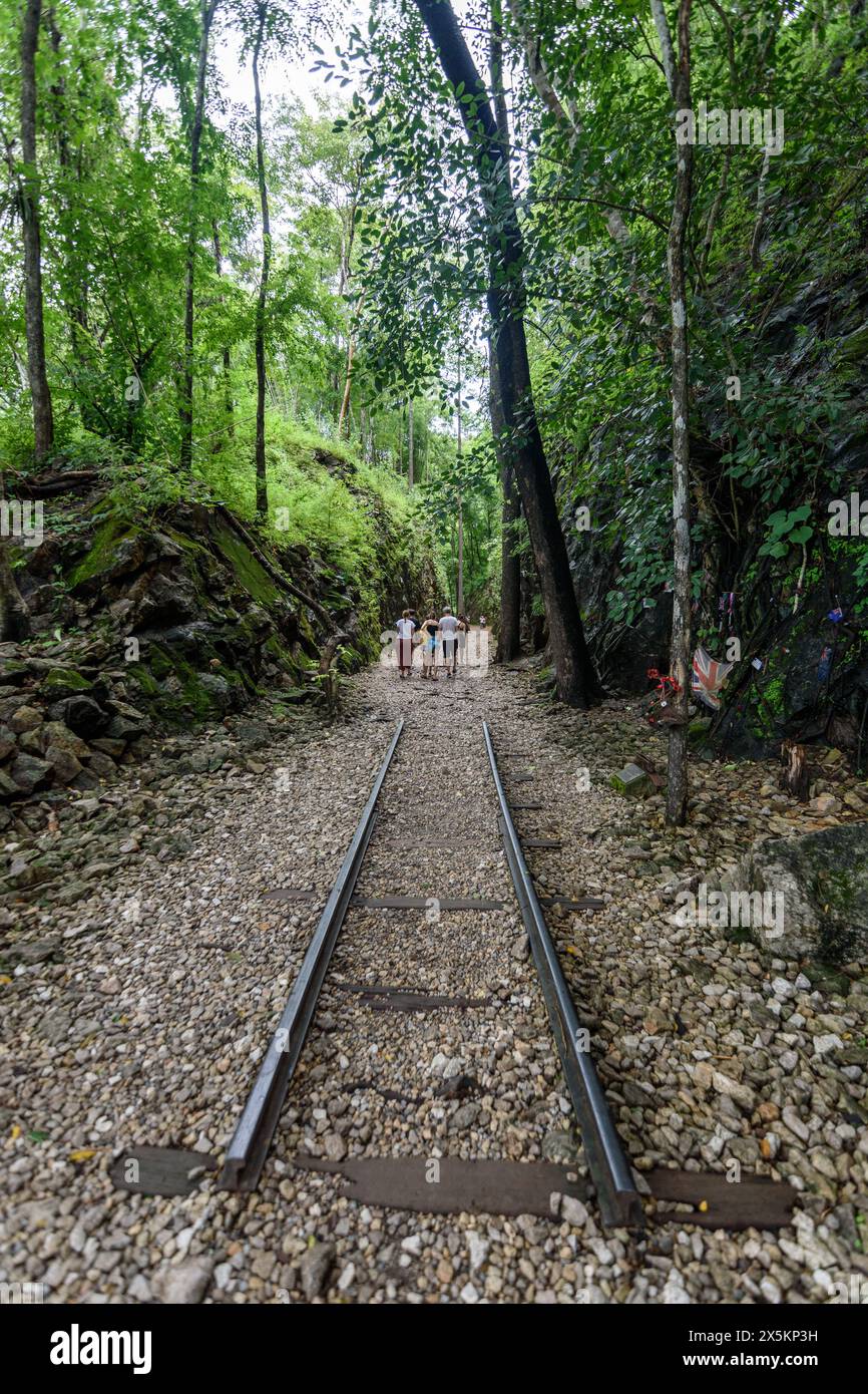 Group of people walking along railroad tracks in a forest in Bangkok. Stock Photo