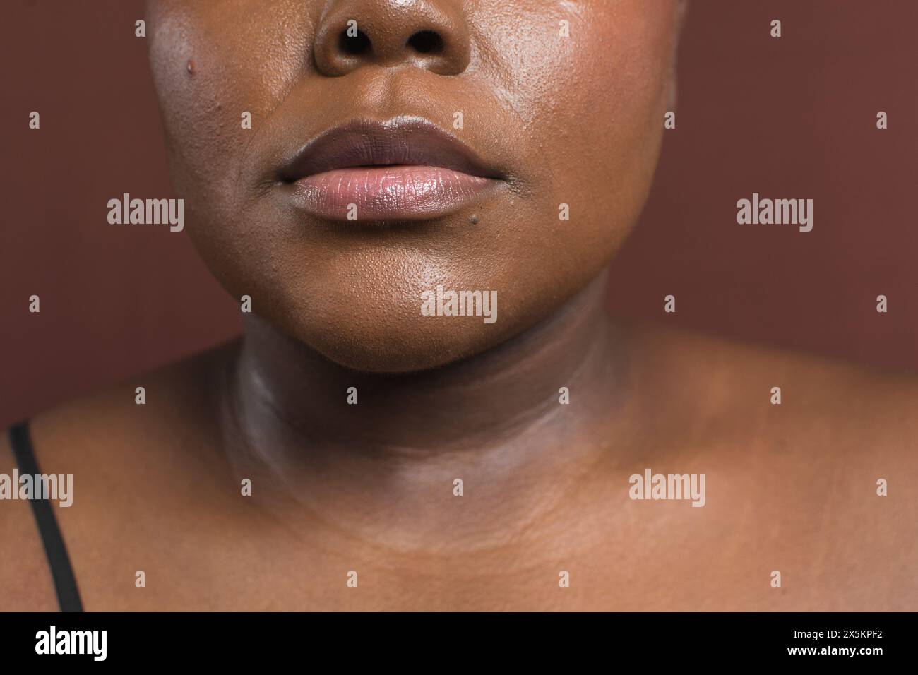 Brown skin woman with even skin tone, dark skin woman with foundation applied on her face Stock Photo